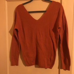 Worn once orange light sweater with cross back